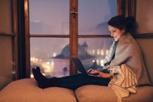 Girl Using Laptop at light